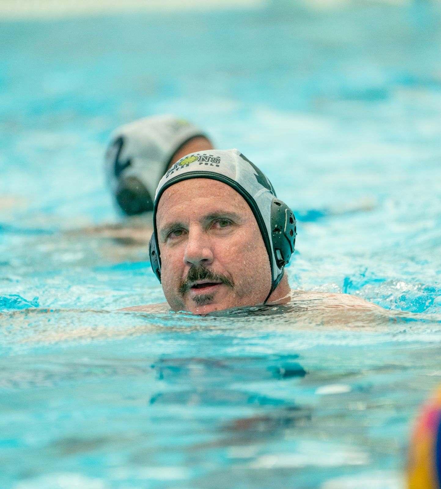 Masters water polo player swimming